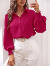 a woman wearing a pink blouse and white pants