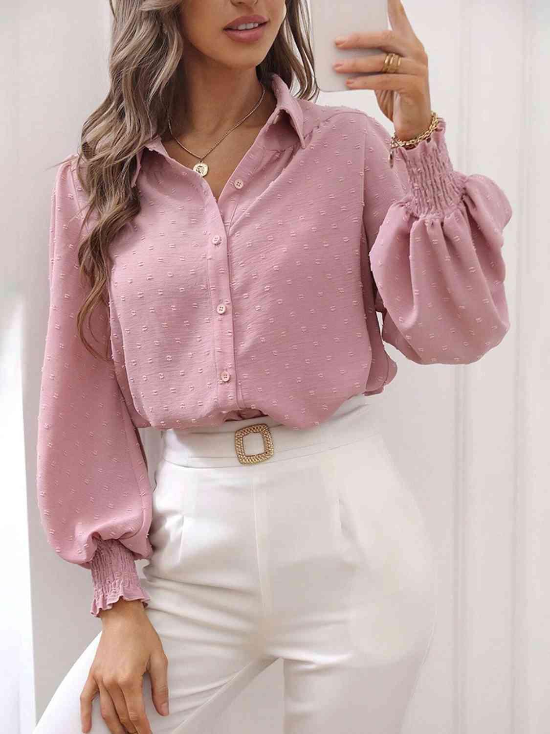 a woman wearing a pink blouse and white pants