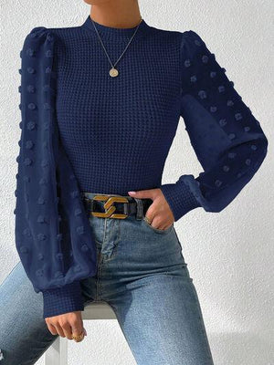 a woman wearing a blue sweater and jeans