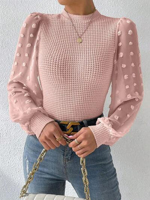 a woman in a pink top holding a white purse