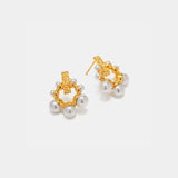 a pair of gold and pearl earrings