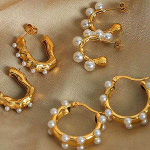 four pairs of gold and pearl hoop earrings