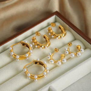 a set of five pairs of earrings in a box