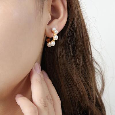 a close up of a person wearing a pair of earrings