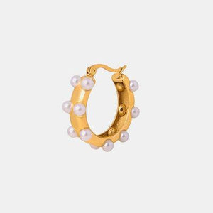 a pair of gold hoop earrings with pearls