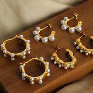 six pairs of gold and pearl hoop earrings