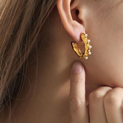 a close up of a person wearing a pair of earrings