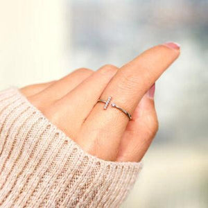 a woman's hand with a diamond ring on it