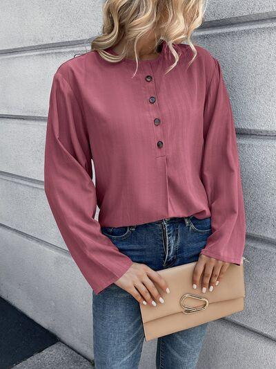 a woman wearing a pink blouse and jeans