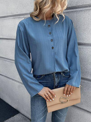 a woman wearing a blue shirt and jeans