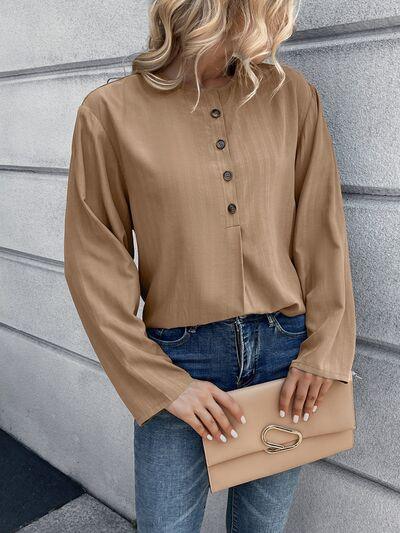 a woman wearing a tan blouse and jeans