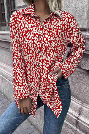 a woman wearing a red and white shirt and jeans