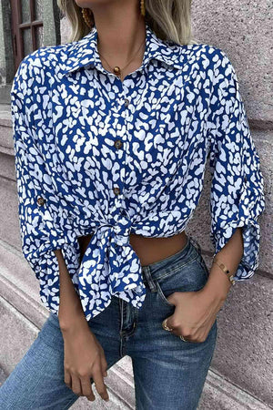 a woman wearing a blue and white shirt and jeans