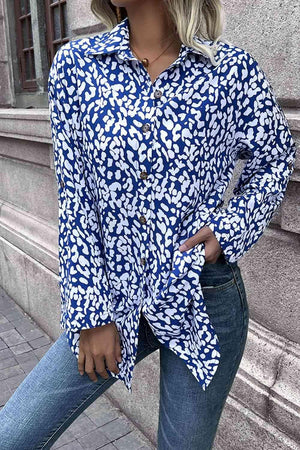 a woman wearing a blue and white shirt and jeans