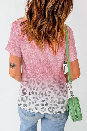 a woman with a green purse and a pink shirt