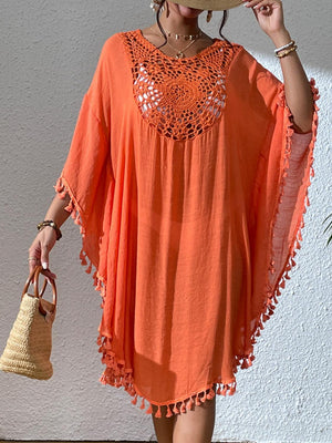 a woman wearing an orange dress and a straw hat
