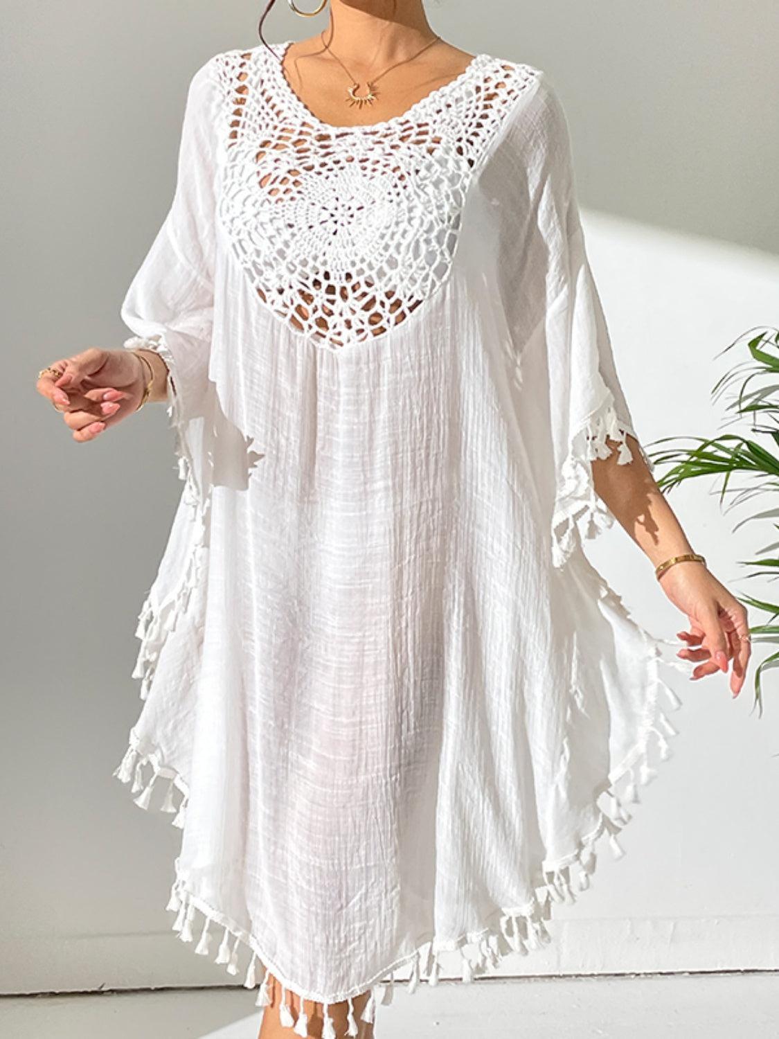 a woman wearing a white crochet cover up