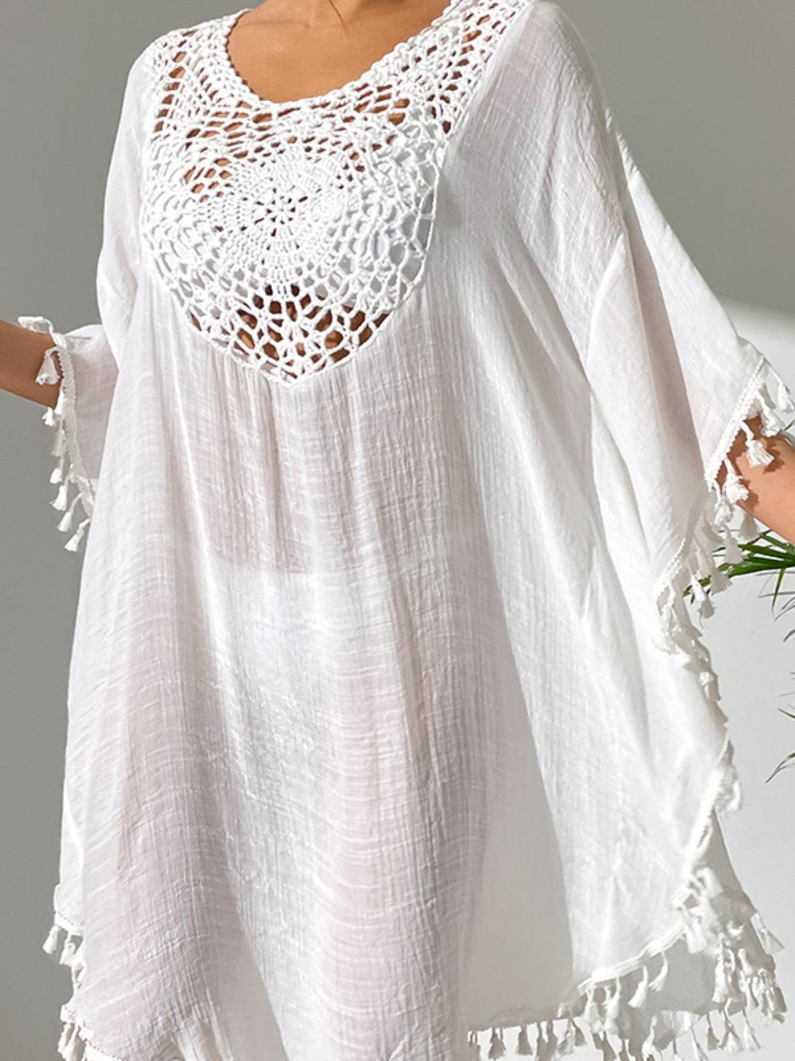 a woman wearing a white top with crochet detailing