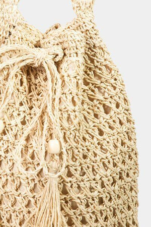 a crocheted bag with a tasseled handle