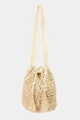 a small beige bag with a tasselled handle