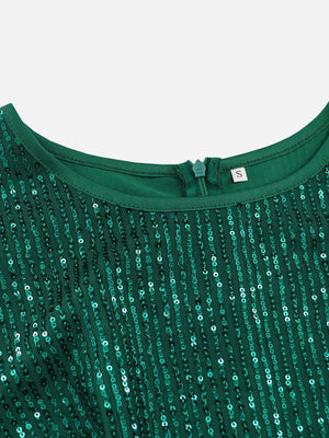 a green top with sequins on it