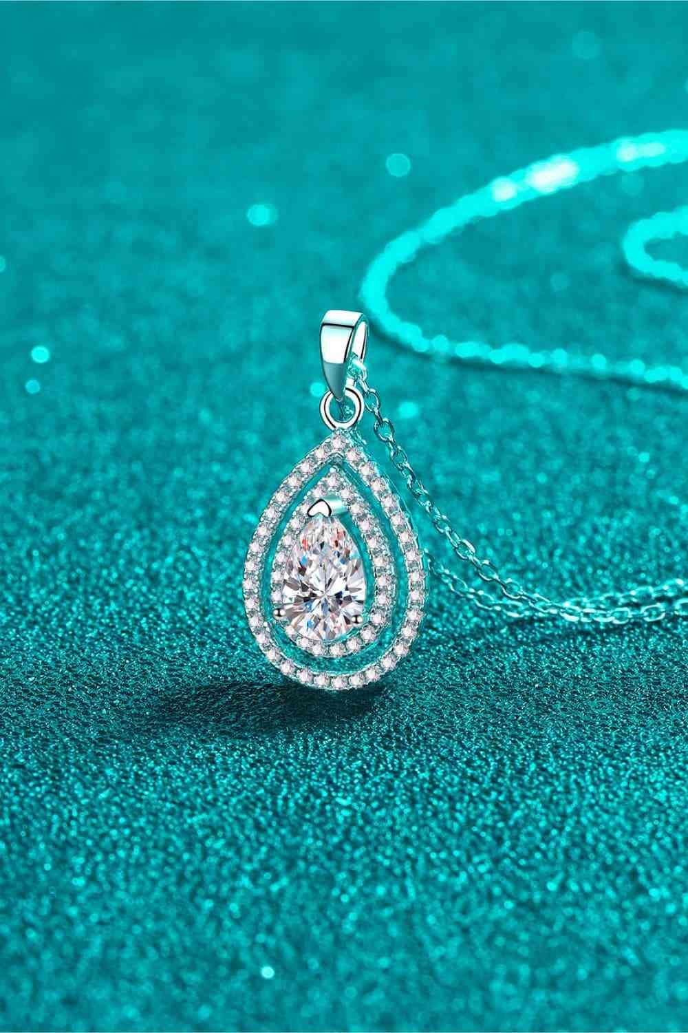 a necklace with a tear shaped diamond on it