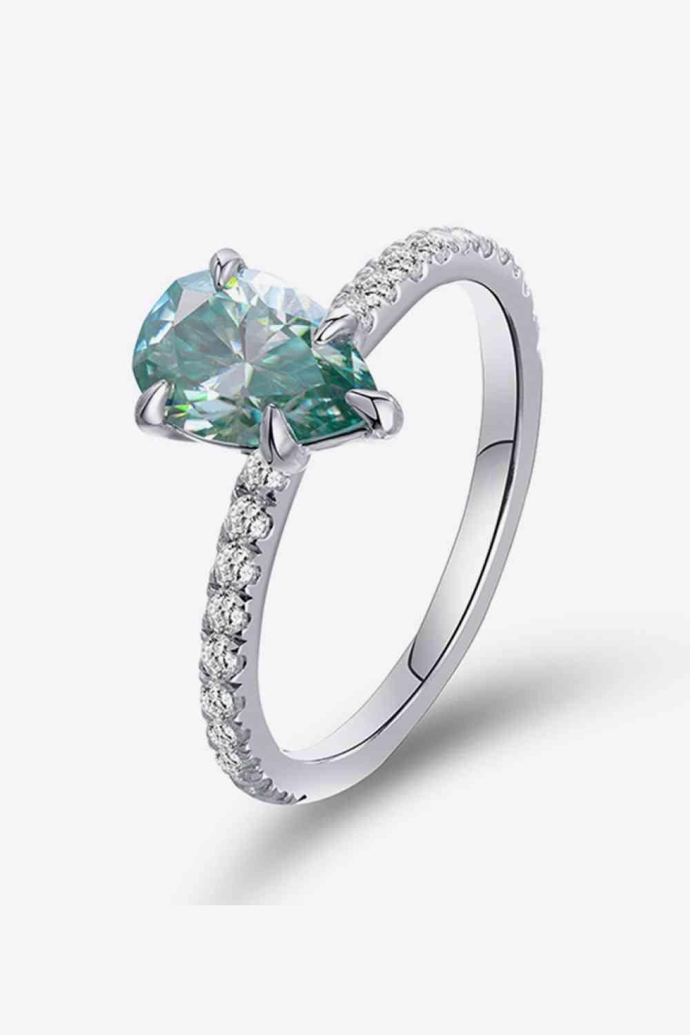 a ring with a heart shaped green diamond