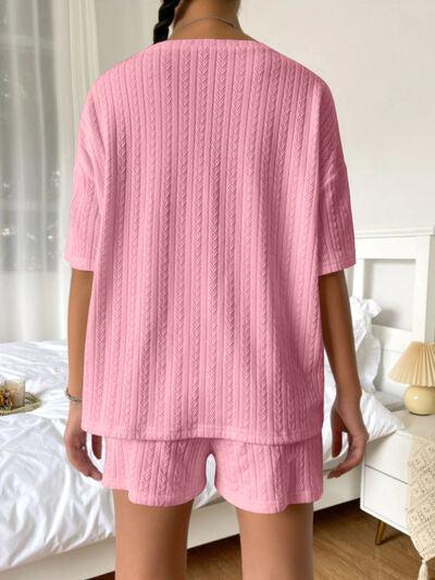 a woman in a pink sweater and shorts