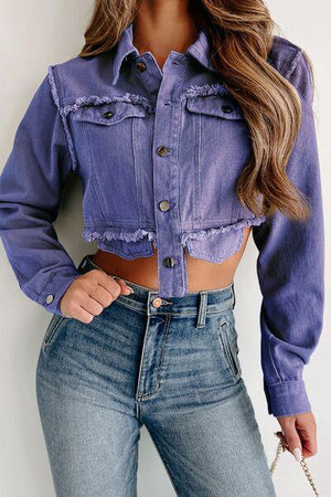 a woman wearing a purple shirt and jeans