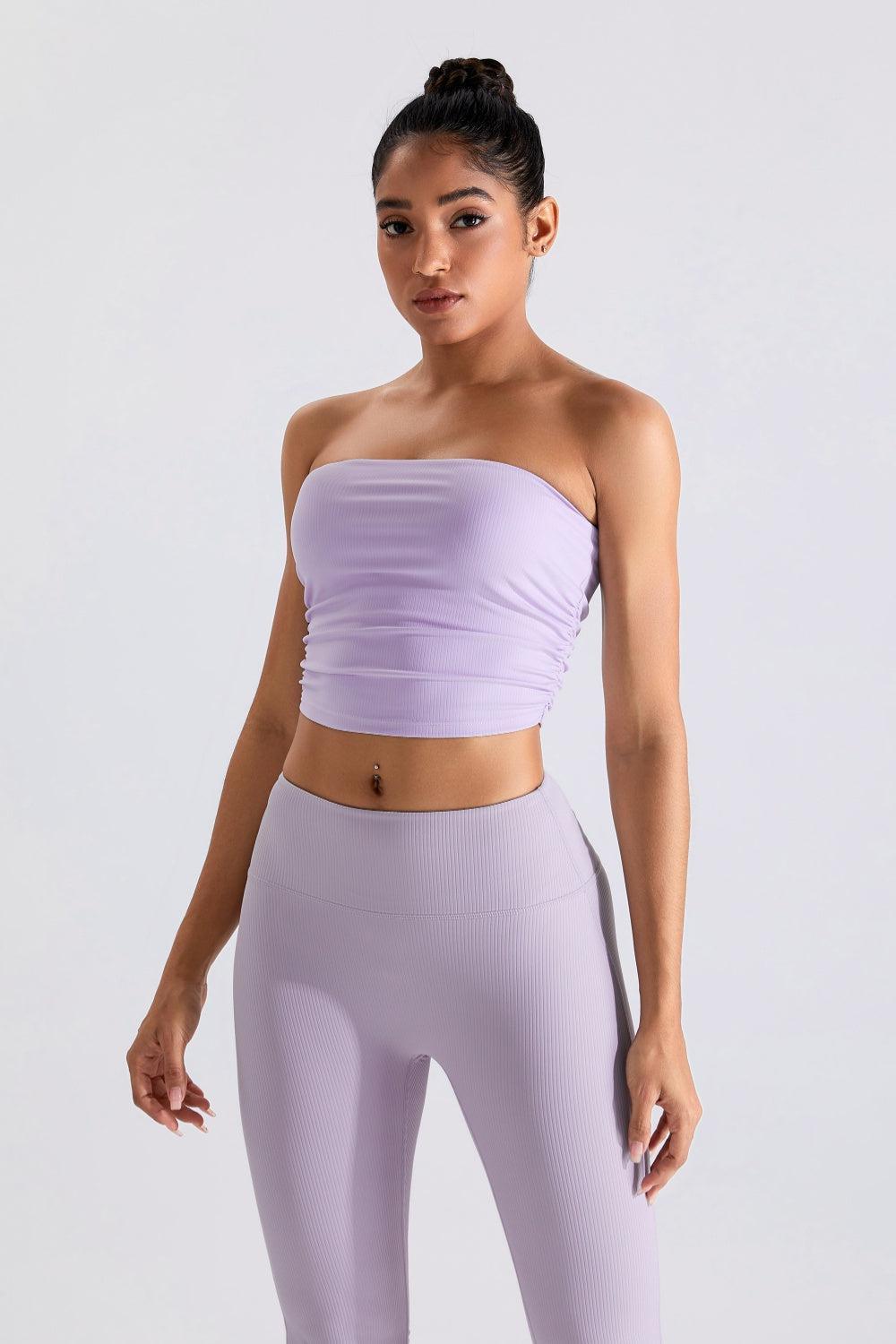 a woman in a purple top and leggings