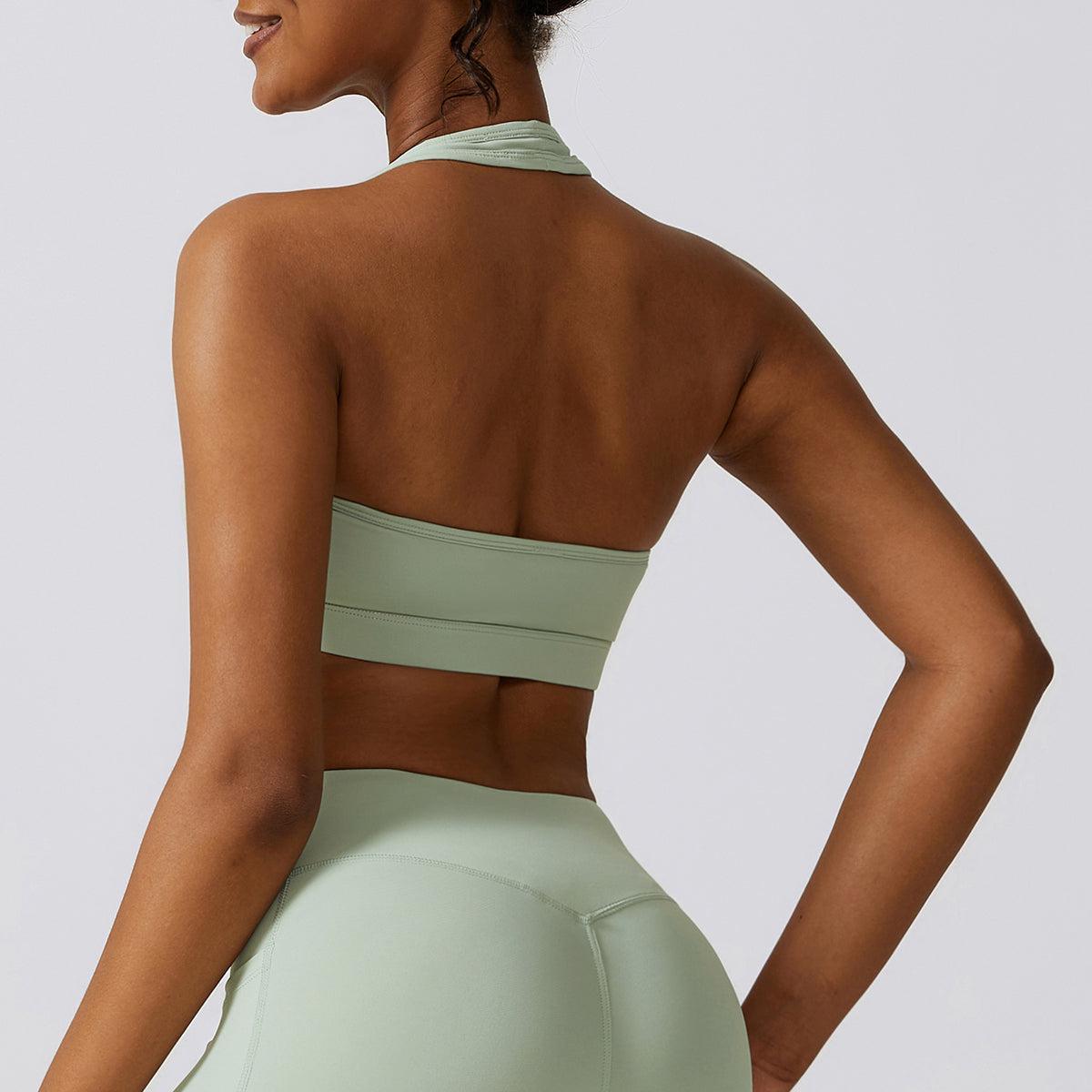 the back of a woman in a green sports bra top