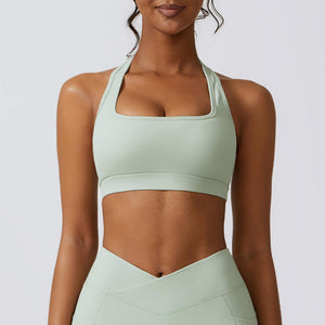 a woman in a light green sports bra top
