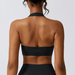the back of a woman wearing a black swimsuit