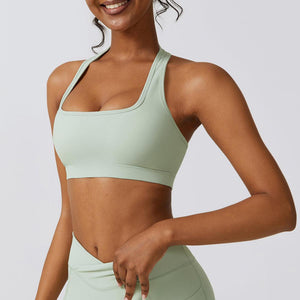 a woman in a light green sports bra top