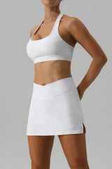 a woman in a white tennis skirt posing for a picture
