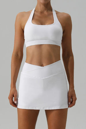 a woman wearing a white tennis skirt and top