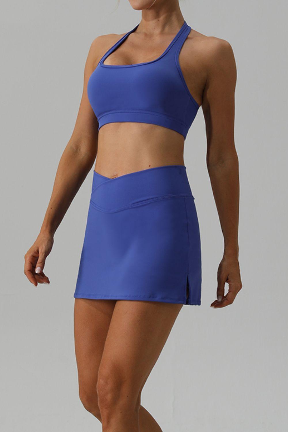 a woman in a blue sports bra top and skirt