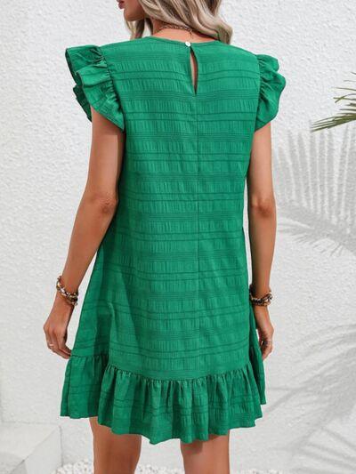 a woman wearing a green dress and sandals