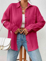 a woman standing on a stool wearing a pink shirt