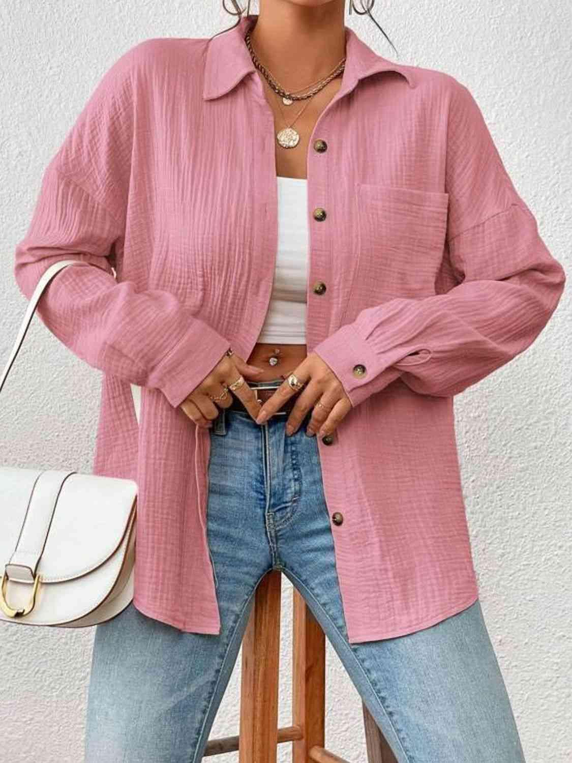 a woman standing on a stool wearing a pink jacket