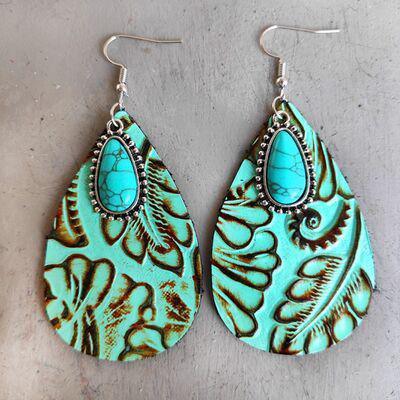 a pair of turquoise and brown earrings