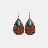 a pair of brown and turquoise earrings