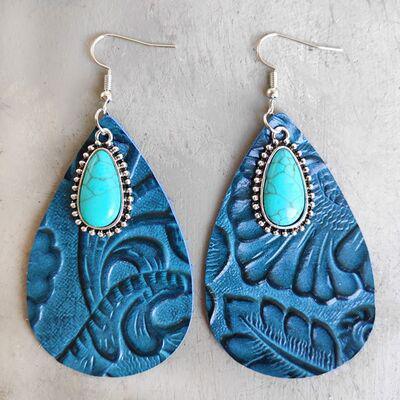 a pair of blue earrings with a turquoise tear
