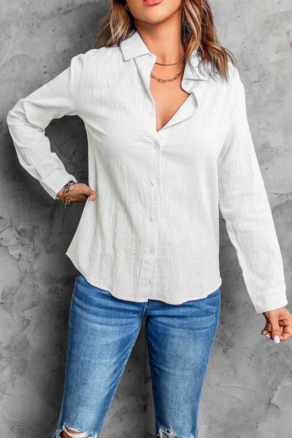 a woman wearing ripped jeans and a white shirt