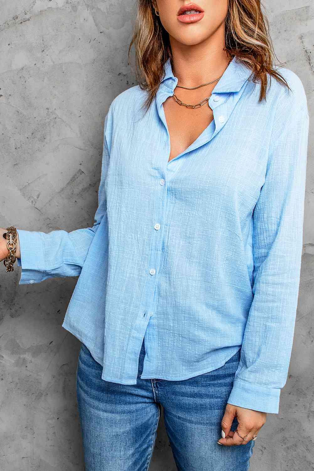 a woman wearing a blue shirt and jeans