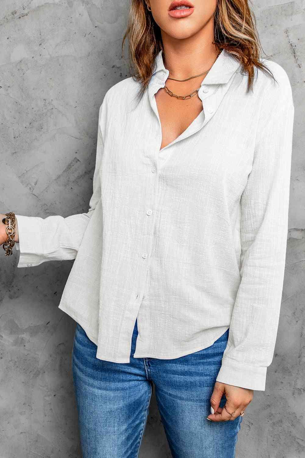a woman wearing a white shirt and jeans