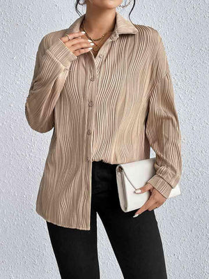 a woman wearing a tan shirt and black pants