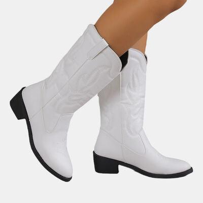 a close up of a person wearing white cowboy boots