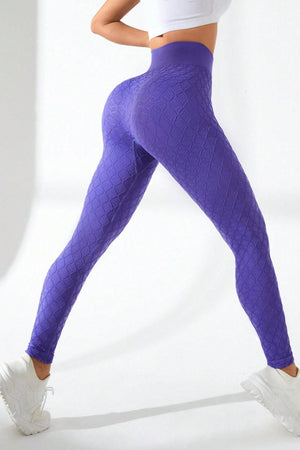 a woman in a white top and purple leggings