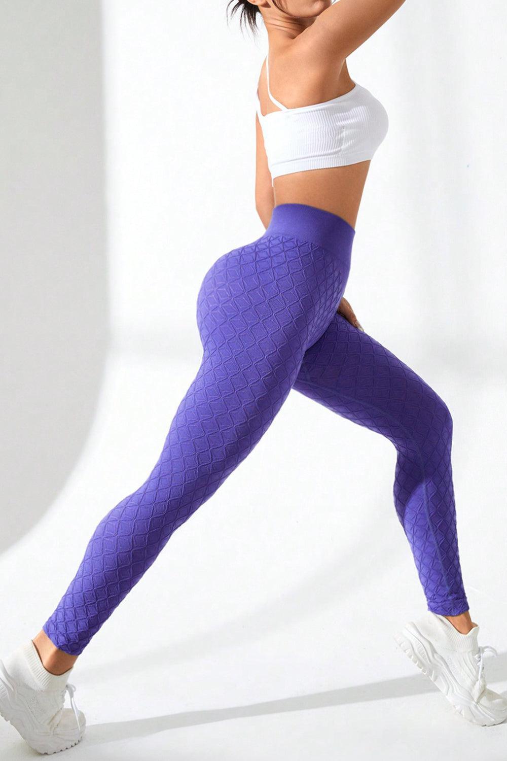 a woman in a white top and purple leggings